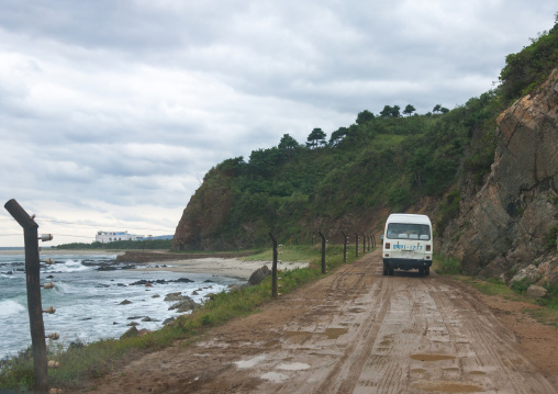 North Korean bus driving on a muddy road along the coast, North Hamgyong Province, Jung Pyong Ri, North Korea