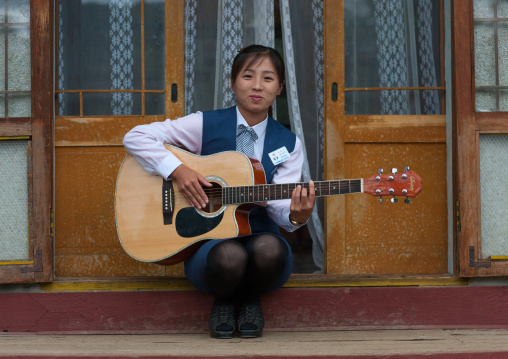 Portrait of a North Korean woman playing guitar, North Hamgyong Province, Jung Pyong Ri, North Korea