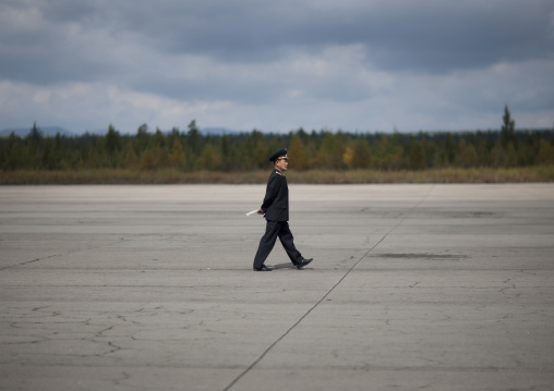 North Korean employee walking on runway Samjiyon airport, Ryanggang Province, Samjiyon, North Korea