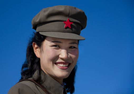 North Korean female guide smiling wearing cap with red star, Ryanggang Province, Samjiyon, North Korea