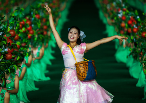 North Korean women dancing between apples during the Arirang mass games in may day stadium, Pyongan Province, Pyongyang, North Korea