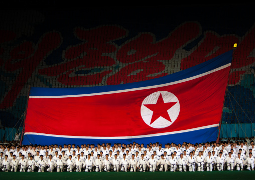 North Korean taekwondo team in front of a giant flag during the Arirang mass games in may day stadium, Pyongan Province, Pyongyang, North Korea