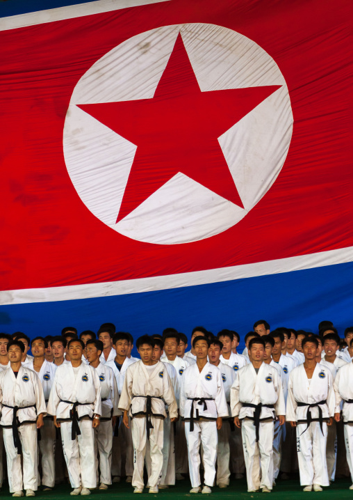 North Korean taekwondo team in front of a giant flag during the Arirang mass games in may day stadium, Pyongan Province, Pyongyang, North Korea
