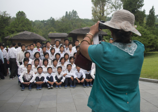 North Korean teacher taking a photo souvenir at Kim il Sung Mangyongdae native house, Pyongan Province, Pyongyang, North Korea