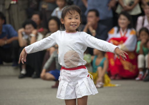 North Korean young girl dancing in the street on national day, Pyongan Province, Pyongyang, North Korea