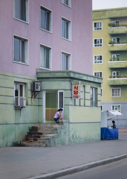 North Korean woman using mobile phone in the street, Pyongan Province, Pyongyang, North Korea