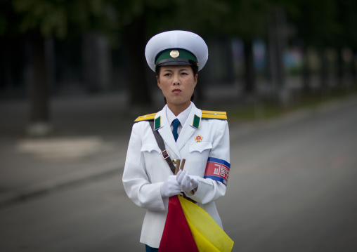 North Korean female traffic security officer in white uniform in the street, Pyongan Province, Pyongyang, North Korea