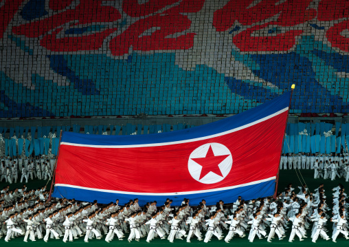 North Korean taekwondo team in front of a giant flag during the Arirang mass games in may day stadium, Pyongan Province, Pyongyang, North Korea