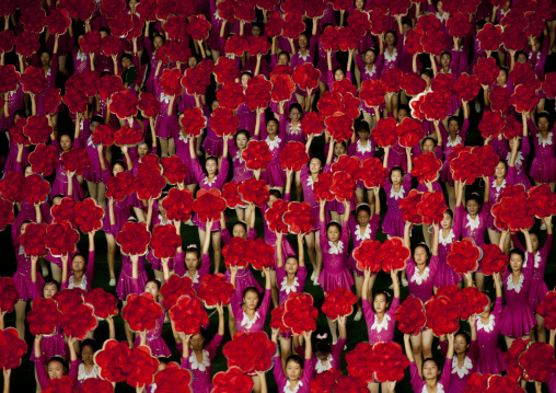 North Korean gymnasts holiding red flowers during Arirang mass games in may day stadium, Pyongan Province, Pyongyang, North Korea