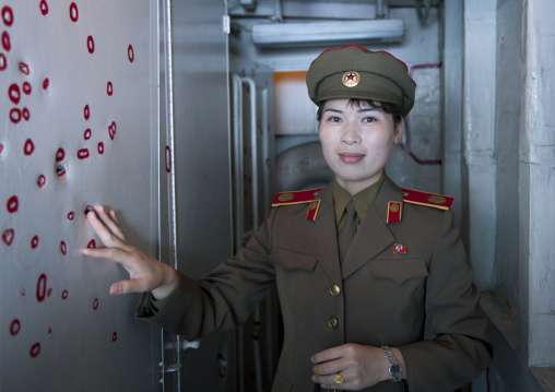 North Korean guide in the Uss Pueblo american spy ship showing bullet holes
, Pyongan Province, Pyongyang, North Korea