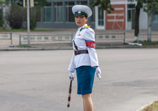 North Korean female traffic security officer in white uniform in the street, Pyongan Province, Pyongyang, North Korea