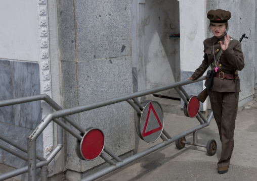 North Korean female solidier at a gate with rifle in Pyongyang film studio, Pyongan Province, Pyongyang, North Korea