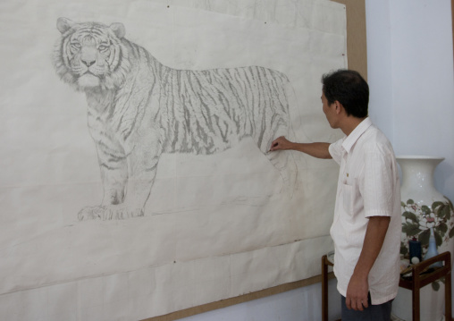 North Korean artist drawing a tiger at Mansudae art studio, Pyongan Province, Pyongyang, North Korea