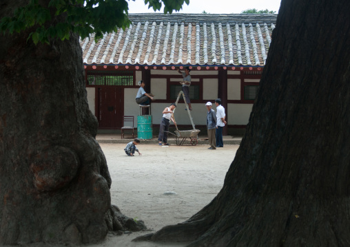 North Korean workers repairing a roof in a museum, North Hwanghae Province, Kaesong, North Korea
