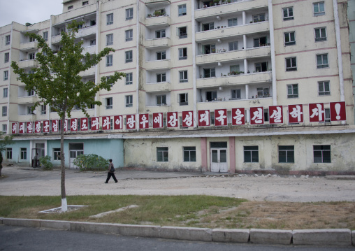 Run down apartment blocks with a propaganda billboard, North Hwanghae Province, Kaesong, North Korea
