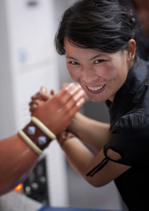 North Korean woman arm wrestling at Kaeson youth park, Pyongan Province, Pyongyang, North Korea