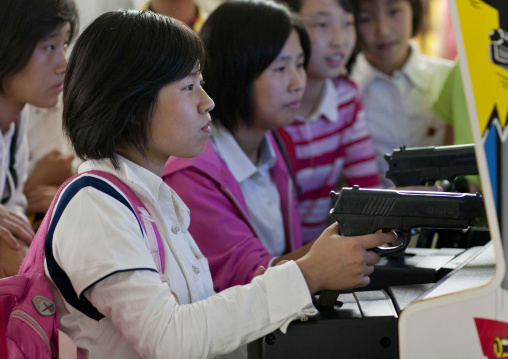North Korean girls playing video game with gun at kaesong youth park, Pyongan Province, Pyongyang, North Korea