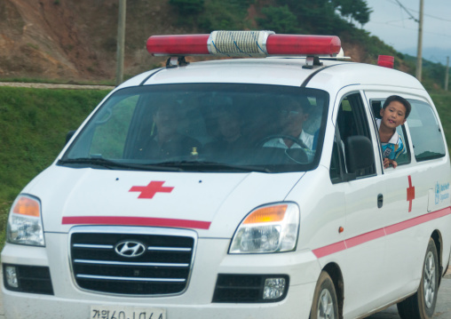 North Korean child in the window of an ambulance on the road, Kangwon-do, Kumgang, North Korea