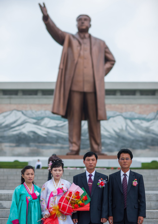 North Korean couples celebrating their wedding in front of Kim il Sung statue in Mansudae Grand monument, Pyongan Province, Pyongyang, North Korea