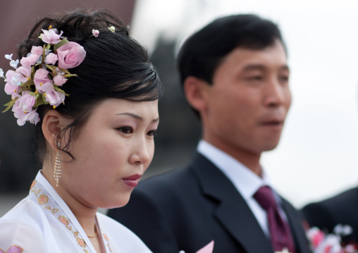 North Korean couple celebrating their wedding in Mansudae Grand monument, Pyongan Province, Pyongyang, North Korea