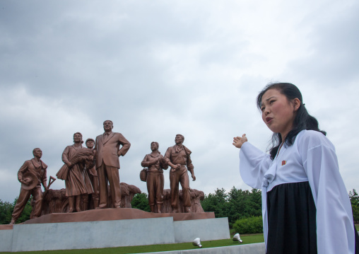 North Korean guide in front of a Kim il Sung statue, South Pyongan Province, Chongsan-ri Cooperative Farm, North Korea