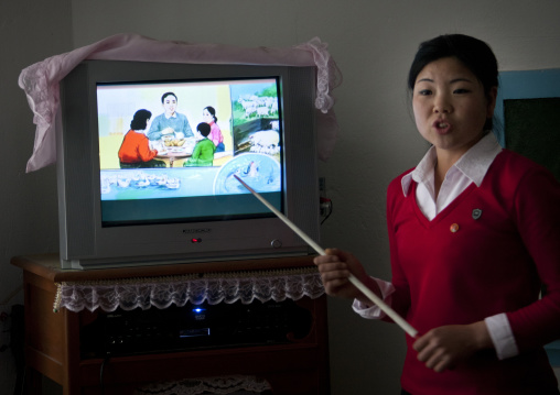 North Korean teacher in a classroom in front of a television, South Pyongan Province, Chongsan-ri Cooperative Farm, North Korea