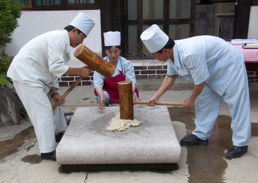 North Korean cooks banging rice in a restaurant, North Hwanghae Province, Kaesong, North Korea