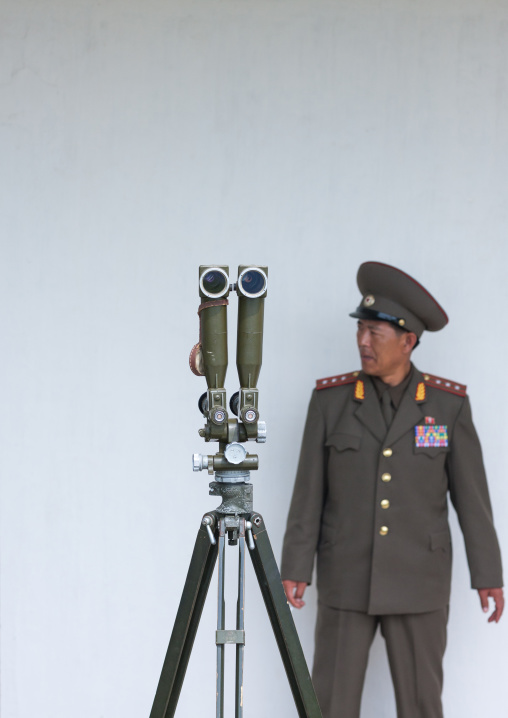 North Korean officer standing near binoculars on the Demilitarized Zone, North Hwanghae Province, Panmunjom, North Korea