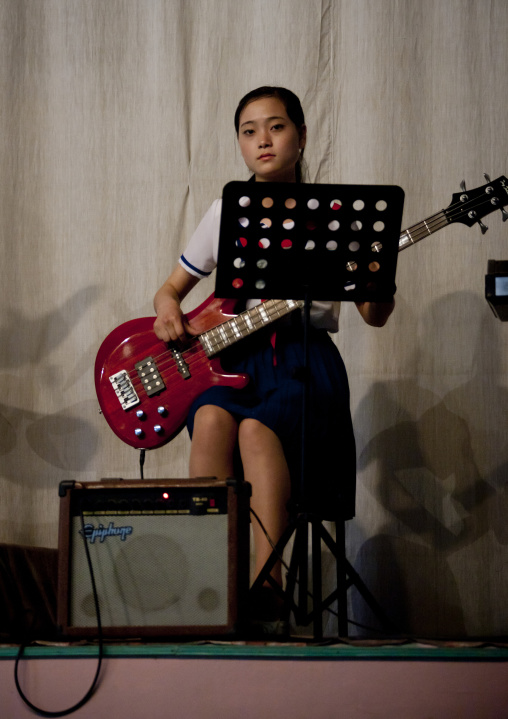 North Korean girl playing bass during a show for tourists in a school, Pyongan Province, Pyongyang, North Korea