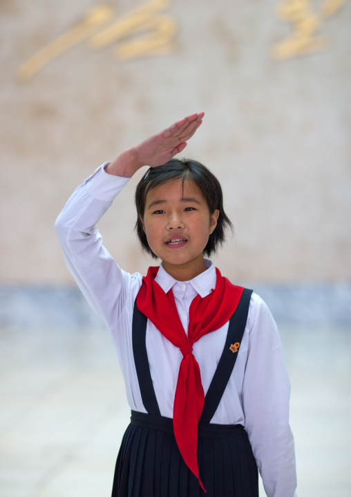 North Korean pioneer girl saluting in the Mangyongdae children's palace, Pyongan Province, Pyongyang, North Korea