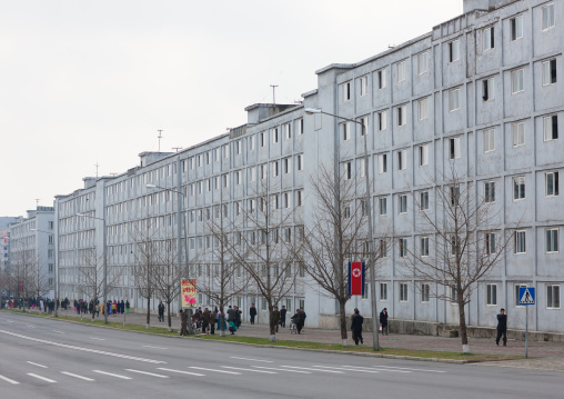 North Korean people walking on a sidewalk along buildings, Pyongan Province, Pyongyang, North Korea