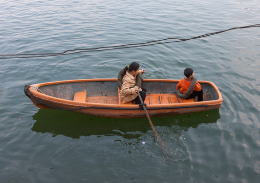 North Korean people paddling on small boats on Taedong river, Pyongan Province, Pyongyang, North Korea