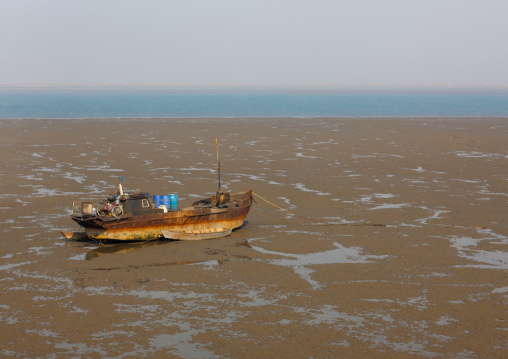 North Korean fishermen boat at low tide, South Pyongan Province, Nampo, North Korea