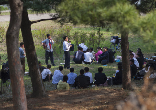 North Korean people having picnic and singing in a park, Pyongan Province, Pyongyang, North Korea