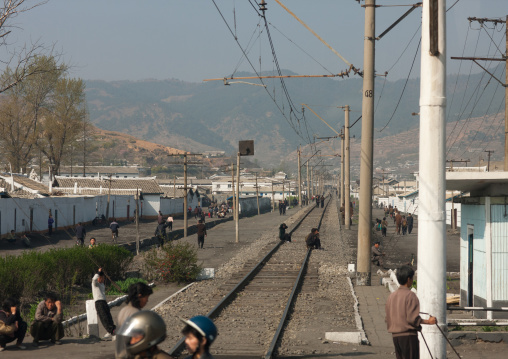 North Korean people sit on an empty railways, Kangwon Province, Wonsan, North Korea