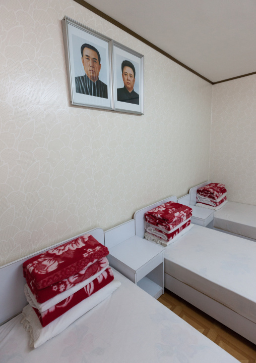Bedroom with the official portraits of the Dear Leaders in Songdowon international children's camp, Kangwon Province, Wonsan, North Korea