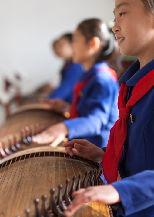 North Korean girls playing kayagum in Mangyongdae schoolchildren's palace, Pyongan Province, Pyongyang, North Korea