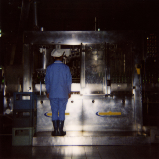 Polaroid of a North Korean female worker in kangso yaksu mineral water factory, South Pyongan Province, Nampo, North Korea