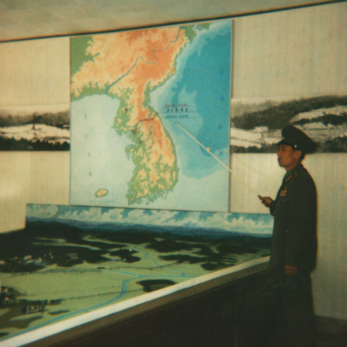 Polaroid of a North Korean soldier in the joint security area in front of the map of Korea, North Hwanghae Province, Panmunjom, North Korea