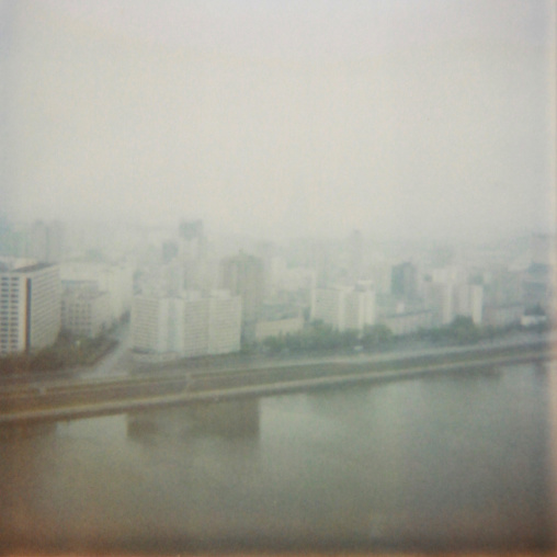 Polaroid of buildings in front of Taedong river in the fog, Pyongan Province, Pyongyang, North Korea