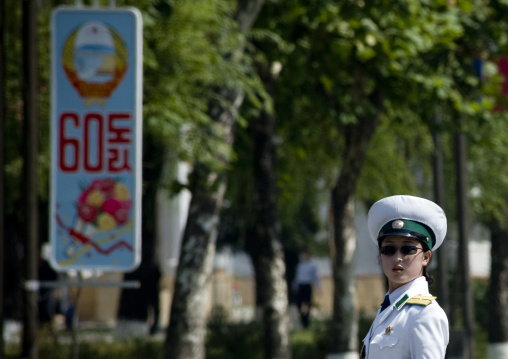 North Korean female traffic security officer in white uniform in the street, Pyongan Province, Pyongyang, North Korea