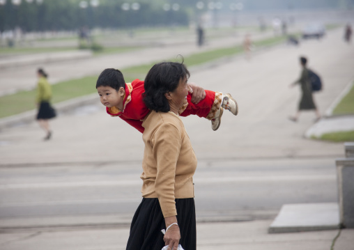 North Korean mother playing with her child in the street, Pyongan Province, Pyongyang, North Korea