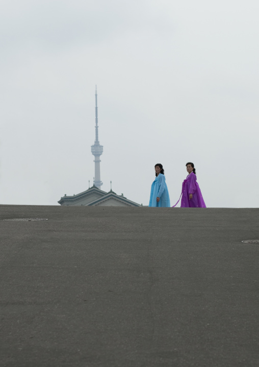 Two North Korean women in traditional choson-ot in front of the television tower, Pyongan Province, Pyongyang, North Korea