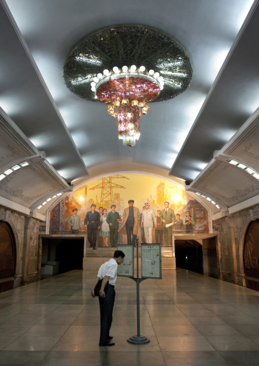 North Korean people reading the offical state newspaper in a subway station, Pyongan Province, Pyongyang, North Korea