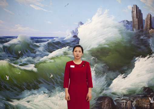 North Korean waitress in a restaurant in front of a mural painting, South Pyongan Province, Nampo, North Korea
