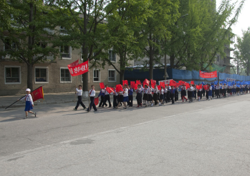Young North Korean pioneers parade in the street, North Hwanghae Province, Kaesong, North Korea