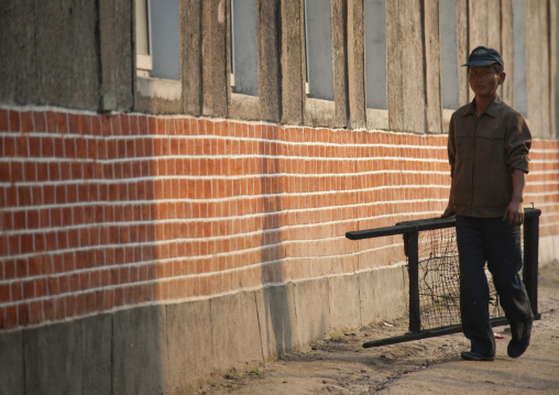 North Korean worker walking in the street, North Hwanghae Province, Kaesong, North Korea