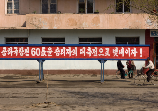 Propaganda slogan on a red billboard in town, South Pyongan Province, Nampo, North Korea