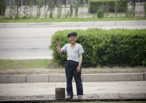 Smiling North Korean teenage boy waving hello in the street, Pyongan Province, Pyongyang, North Korea