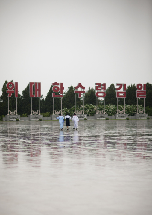North Korean women under the rain in Kumsusan memorial palace, Pyongan Province, Pyongyang, North Korea